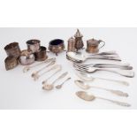 A quantity of silver items to include spoons, forks, napkin rings, tongs, pepper pot, mustard pot