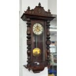 A mahogany wall clock, overall length approx. 100cm.