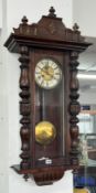 A mahogany wall clock, overall length approx. 100cm.