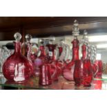 Collection of Victorian and later cranberry glass including four decanters (9 pieces).