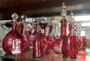 Collection of Victorian and later cranberry glass including four decanters (9 pieces).