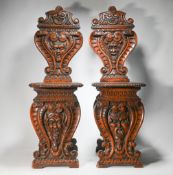 A pair of 19th century hall chairs of Italian, Sgbello style, carved in walnut, height 103cm