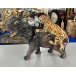 A large Beswick Elephant with Lion on the back.