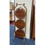 A mahogany three tier cake stand.