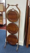 A mahogany three tier cake stand.