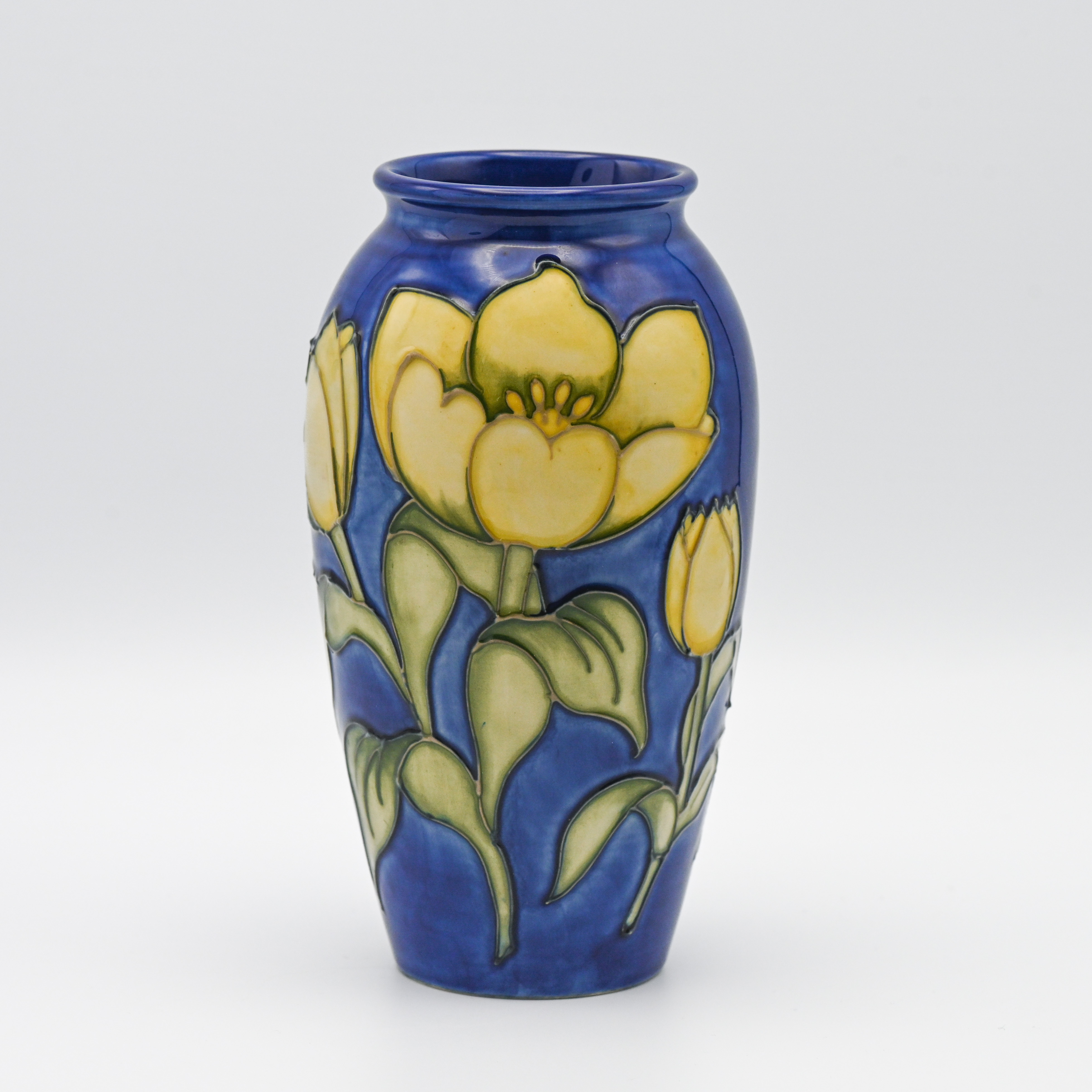 A Moorcroft vase decorated with yellow Tulips on blue background, limited edition of 50, 19cm