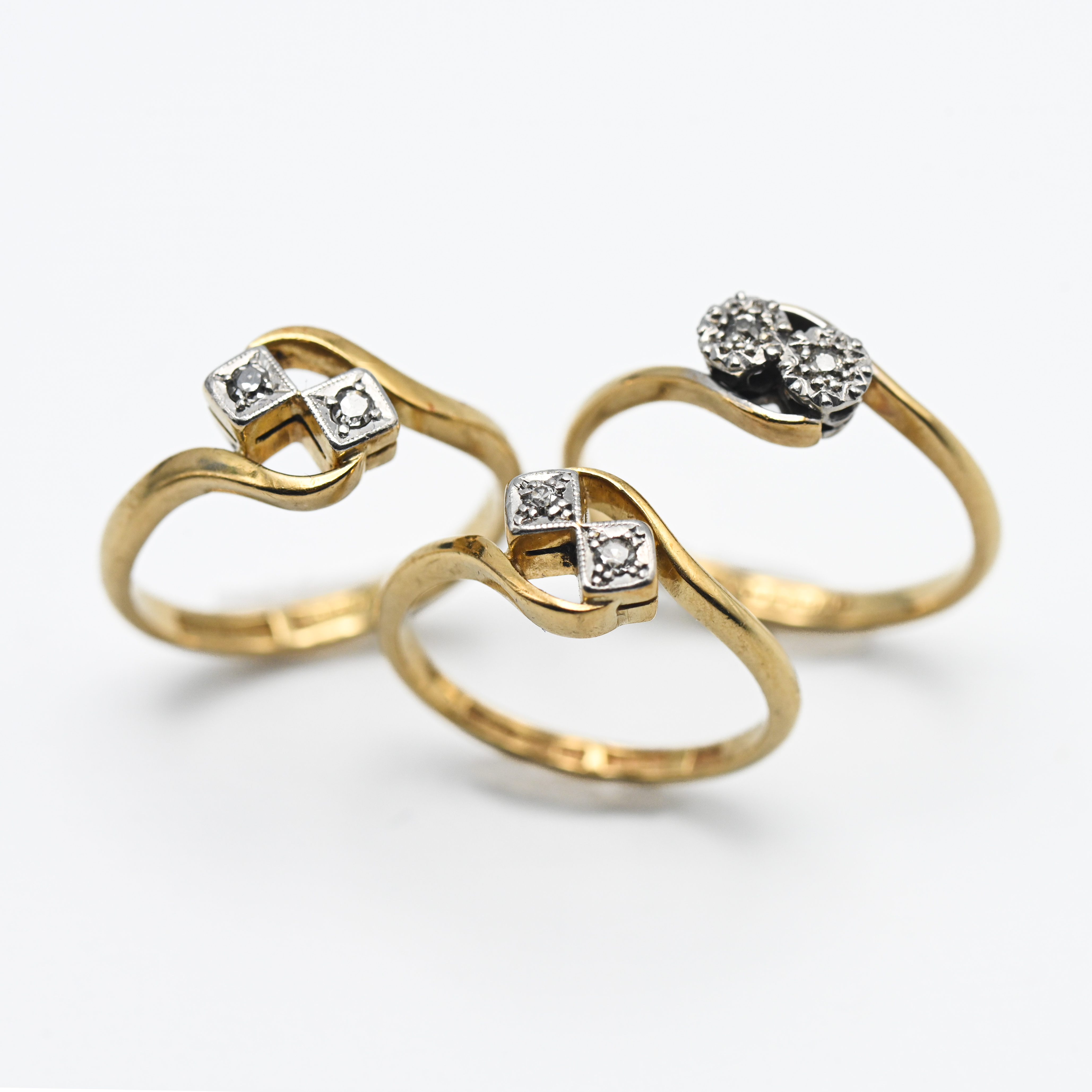 Three 18ct yellow gold and diamond illusion set rings, approx. 8.5g (3).