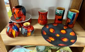 A collection of eight pieces of Poole Pottery including pair of vases, plate etc.