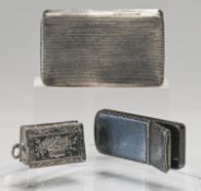 Three white metal snuff / small boxes (two are possibly silver) comprising one with indistinct