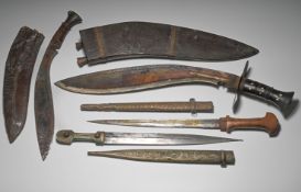 A collection of various knives; two daggers of Indian origin, one with a decoratively engraved metal