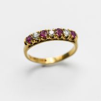 An 18ct gold ring set with seven stones including rubies, size N, 2.8g.