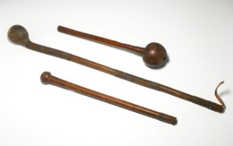 Two African wooden knobkerrie together with a leather knobkerrie (3).