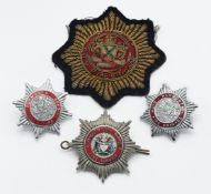 Three metal Plymouth Fire Brigade badges including Plymouth City Airport Fire Service and one