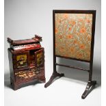 A Japanese red lacquer table cabinet with some contents together with a small fire screen.