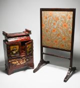 A Japanese red lacquer table cabinet with some contents together with a small fire screen.