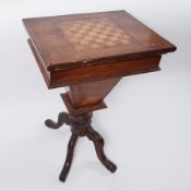 A walnut games table with compartments inside, height 76cm.