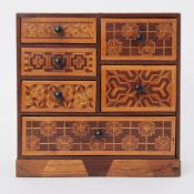 A wooden parquetry inlaid table top collectors cabinet fitted with six drawers, height 30cm.