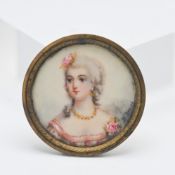 A 19th century portrait circular miniature of a Lady with necklace signed H Deniey?, 35mm.