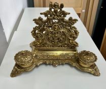 An ornate brass ink stand.