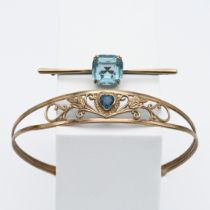 A 9ct gold blue stone bangle decorated with leaves together with a 9ct gold blue stone brooch,