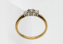 An 18ct gold three stone diamond ring, size Q, 3.4g