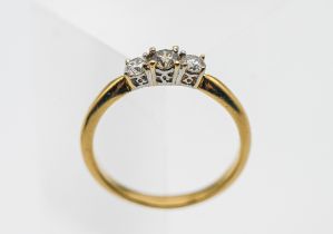 An 18ct gold three stone diamond ring, size Q, 3.4g