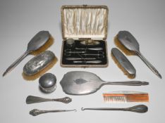 A five piece silver back dressing table set also silver back brush, glass jar and a silver