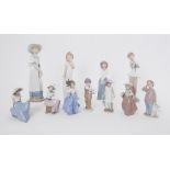 A collection of eleven Nao figures including 'Boy with Football' and 'Girl with Puppy' etc (11).