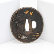 A Japanese Tsuba, Meiji era 19th/20th century Finely decorated in gold and silver inlay on each side