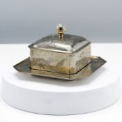 A Chinese Export silver butter dish, cover and stand, of canted square section, incised around the
