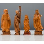 A set of four carved soft wood figures of Immortals, two of Shoulao and two of Guanyin 11.5 to 14.