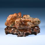 A jade carving of a Chimera and pony group, 17th-19th century. The chimera carved reclining with its