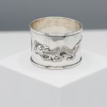 A Chinese silver napkin ring of cylindrical form, cast in relief with two dragons either side of a