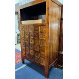 A Chinese style cabinet fitted with twenty four spice drawers with ring drop handles,