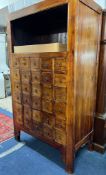 A Chinese style cabinet fitted with twenty four spice drawers with ring drop handles,