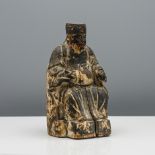 A carved wood figure of an official, possibly early Qing dynasty, carved seated wearing long flowing