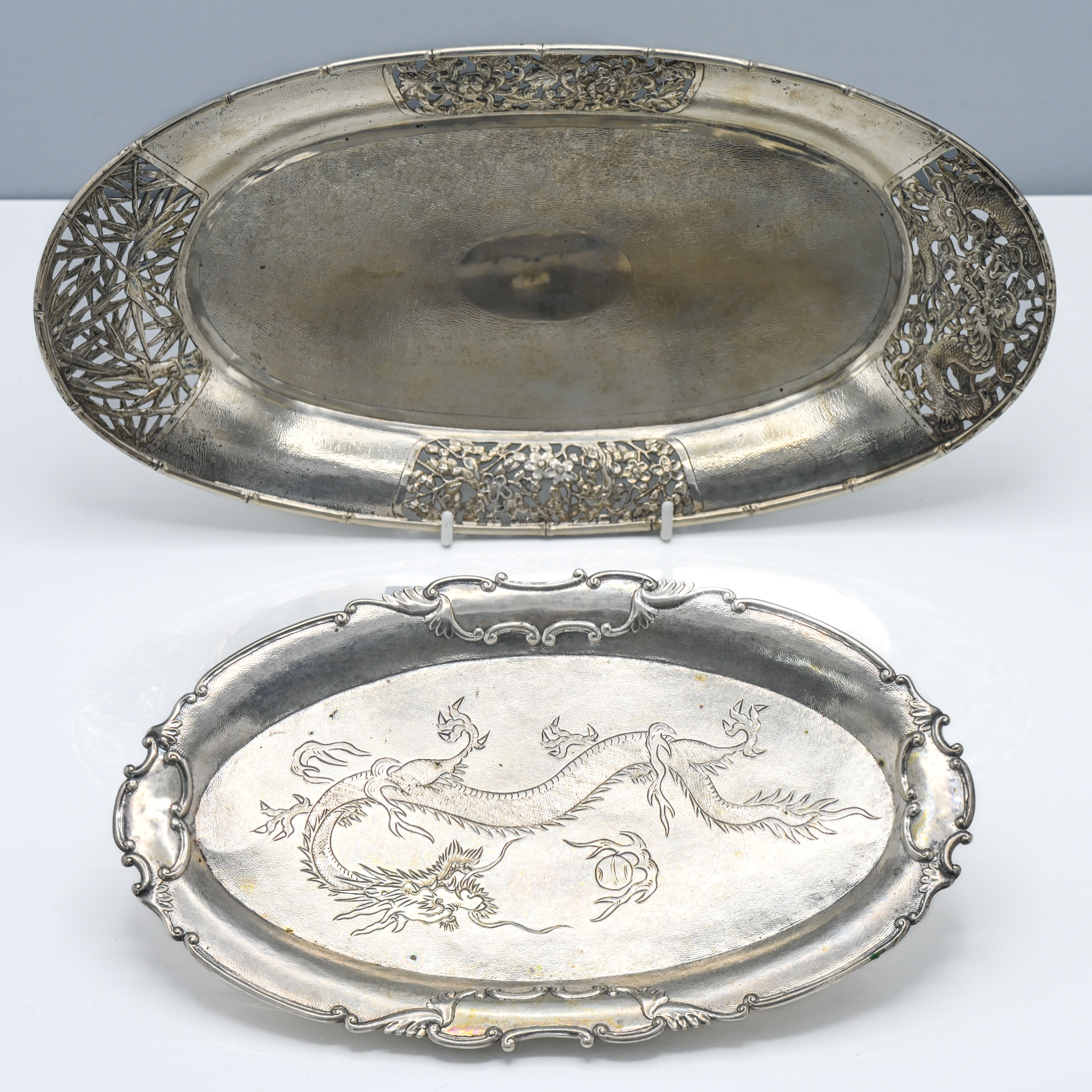 Two oval platters, 19th/20th century, one on four spherical feet