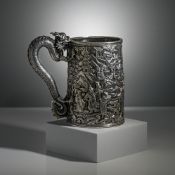 A large silver tankard, 19th century of tapered cylindrical form, cast in relief with numerous