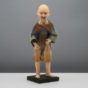 A Chinese papier mâché figure of a fisherman, 19th century. Modelled standing on a square base