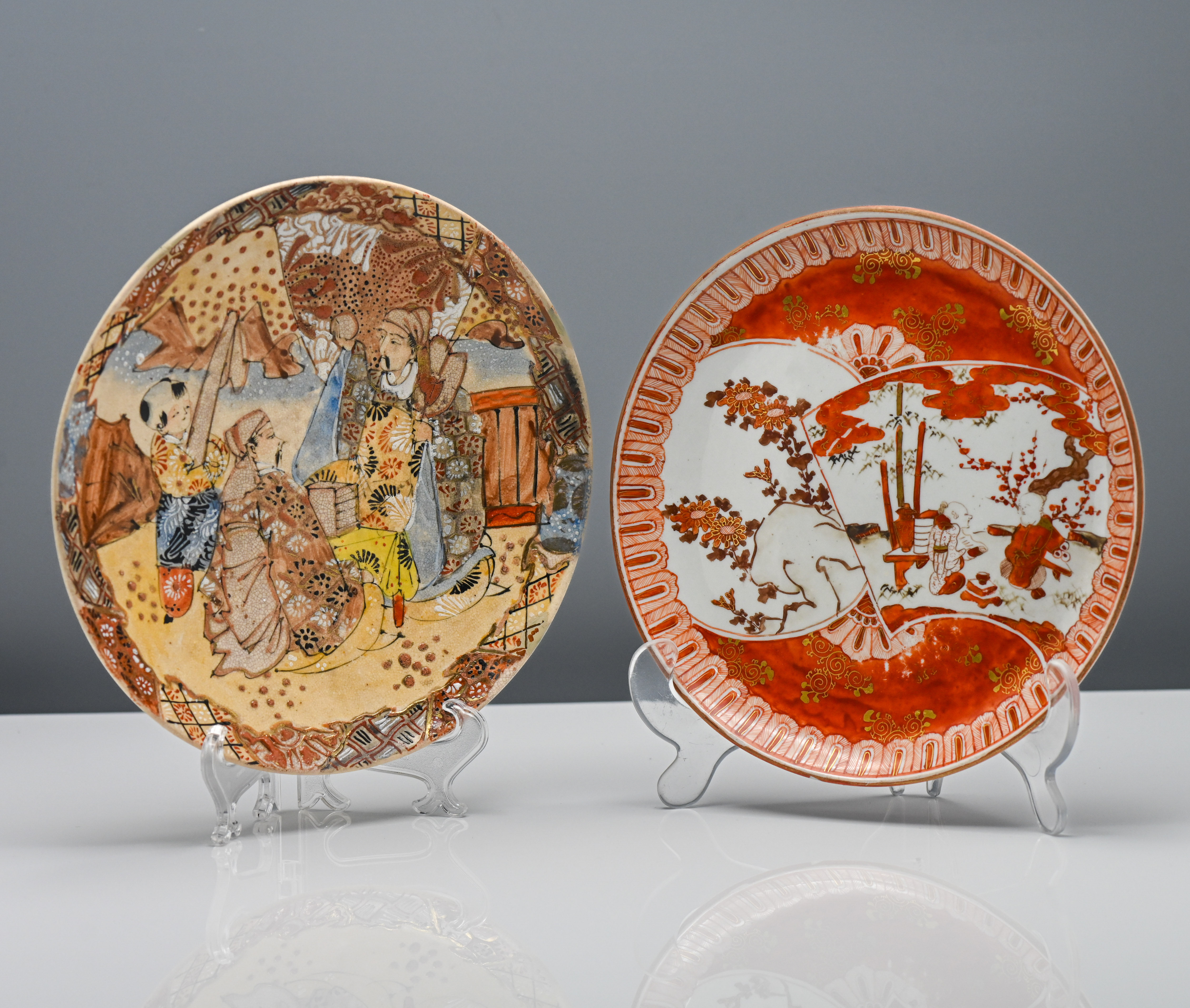 Two Japanese plates. One satsuma earthenware painted with a boy waiting on two dignitaries, the