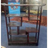 A Chinese damascened hardwood display shelf unit, 19th century. The asymmetrical arrangement over