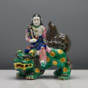 Japanese porcelain figure of Kannon (Guanyin) on a Shishi (Foo dog), Meiji period (1868-1912) The