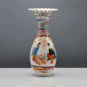 A Japanese Kutani vase, Meiji period or later, 20th century. The pear-shaped body rising to a