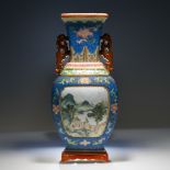A ‘famille-rose’ blue ground scraffiato wall vase, 19th century, the ovoid body with a landscape