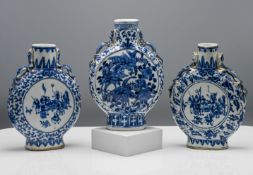 A pair of blue and white moonflasks 'Bianhu,' each with the flattened circular body on a tall foot