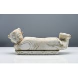 A marble pillow, 19th/20th century, carved in the form of a recumbent boy, his head turned to one