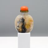 A carved agate snuff bottle, Qing dynasty Finely carved on one side in relief using the inclusions