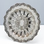 An Export silver salver, 19th century, of circular form on three bracket feet