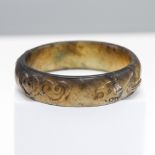 A jade bangle, Qing dynasty (1644-1911) Carved in archaistic style with ‘ruyi’ and zoomorphic