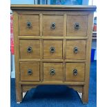 A small Chinese style chest fitted with nine drawers with ring drop handles, light wood,